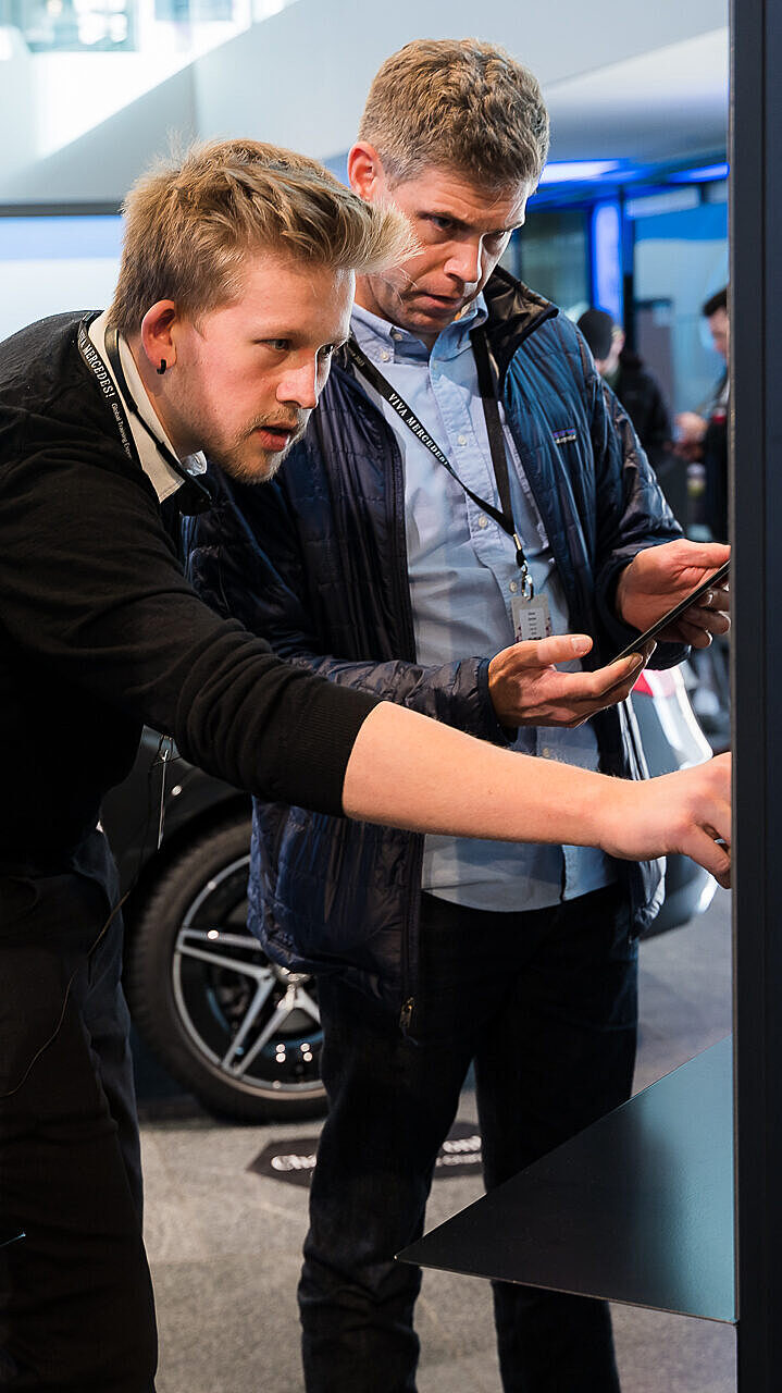 Hands-on demo during the Global Training Experience with participants using interactive displays.