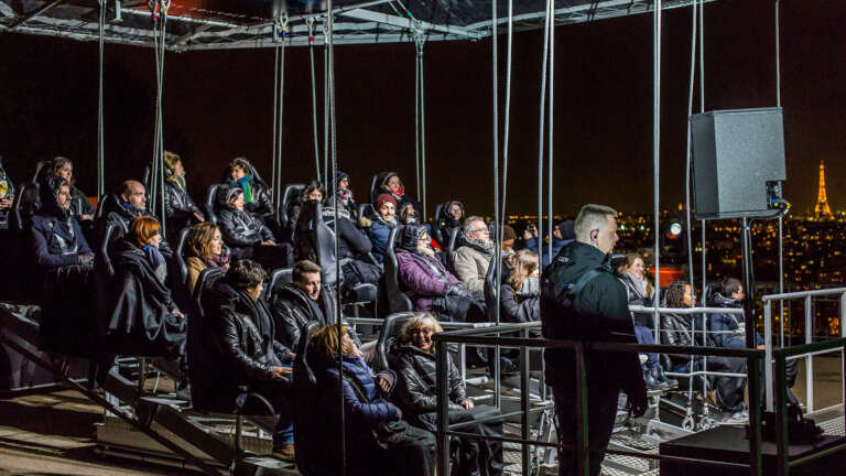 Spectators attend a breathtaking suspended screening with a panoramic view over Paris.