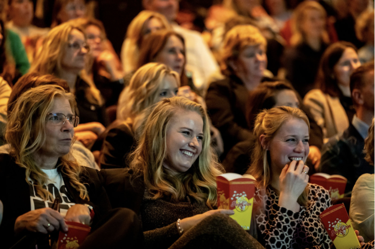 Audience laughing as speaker takes to stage at OVAL event